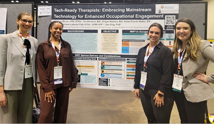 "Image of four women standing in front of a conference poster"